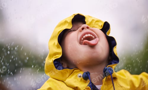 Preview: To enjoy the rainbow, first enjoy the rain. A little girl having fun in the rain.