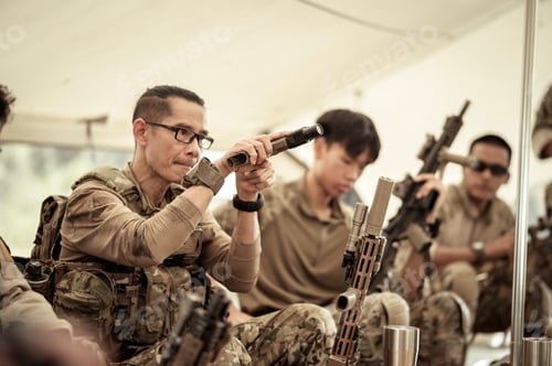 Preview: Soldiers in camouflage uniforms planning on operation in the camp
