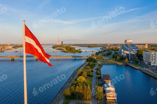 Preview: Aerial shot of the Latvian flag waving in the blue sky in Riga, Latvia
