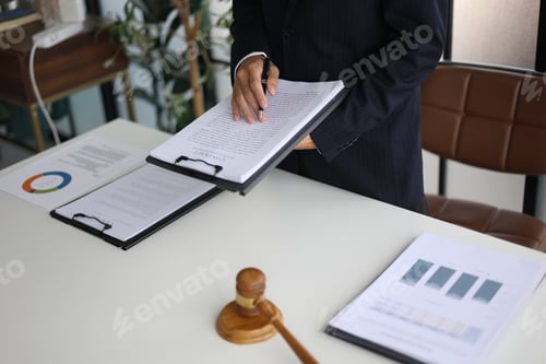 Preview: Legal counsel reading contract paperwork to finalize a legal agreement at his office