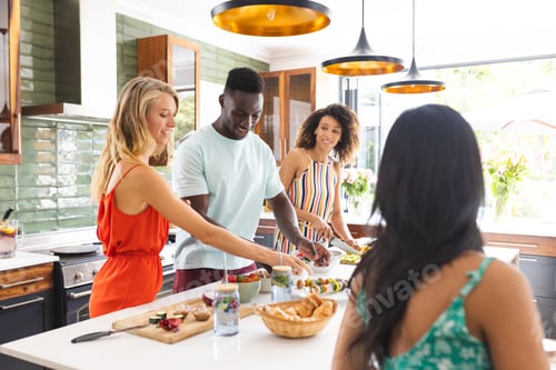 Preview: Young African American man and diverse group of women enjoy preparing food together