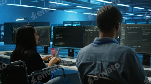 Preview: Person with paraplegia typing data on PC in data center