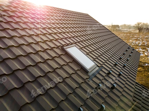 Preview: Close-up of new attic plastic window installed in shingled house roof