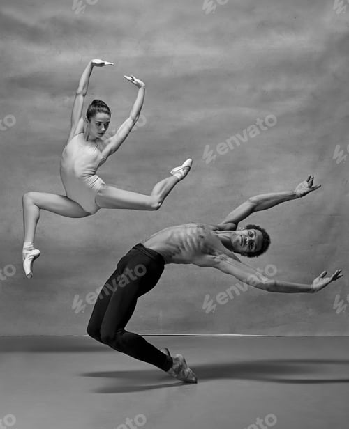 Preview: Couple of ballet dancers posing over gray background