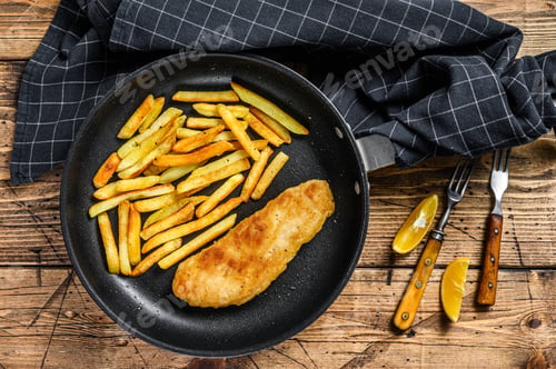 Preview: English Traditional Fish and chips dish with french fries in a pan. Wooden background. Top view