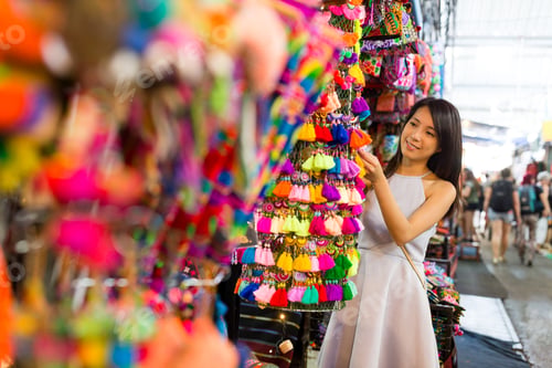 Preview: Young woman go shopping in the street market