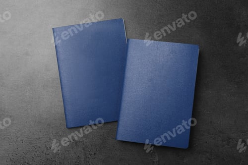 Preview: Blank blue passports on dark grey table, flat lay