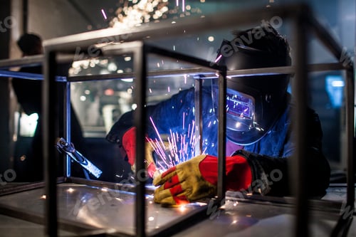 Preview: Welderman welds in protection helmet at the factory. Welder workplace . Welding metal