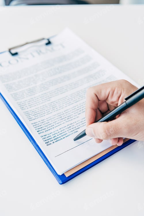 Preview: close-up partial view of business person signing contract