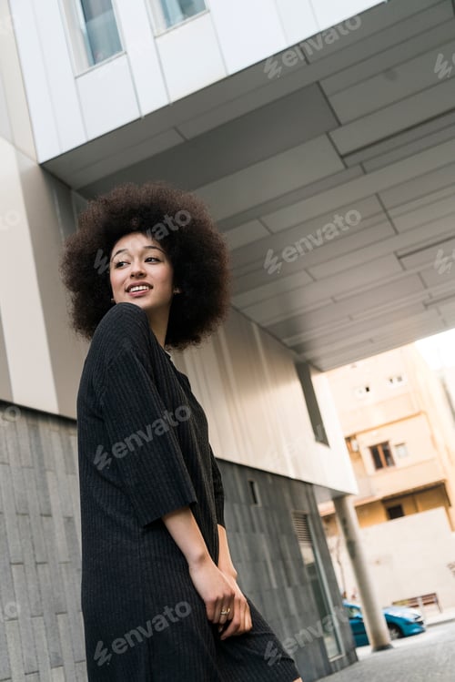 Preview: Portrait of smiling young woman wearing black dress