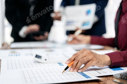 Preview: A person is writing on a piece of paper with a pen