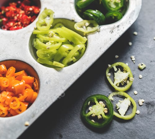 Preview: Closeup of cut chili peppers in metal tray