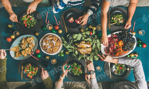 Preview: Human hands holding glasses with drinks and eating at Christmas