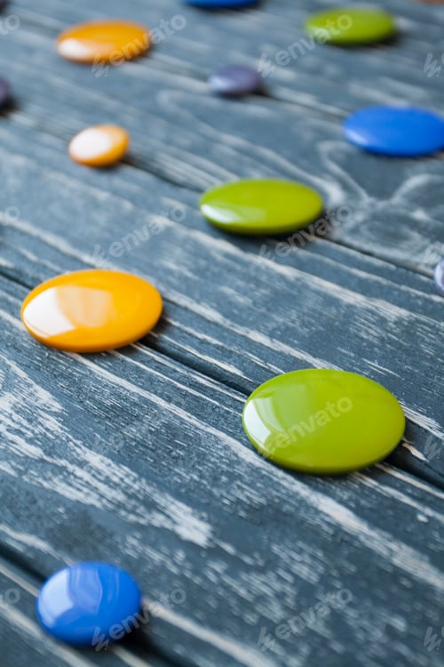 Preview: A set of colorful glass buttons for clothes on a dark wooden background