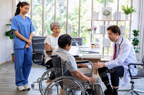 Preview: Senior couple male on wheel chair having consultations with doctor for knee problems at clinic