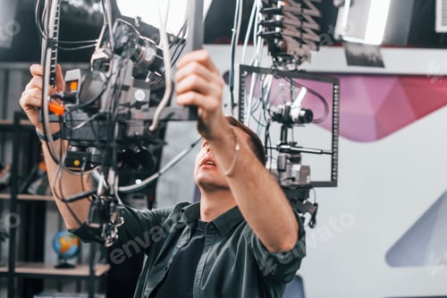 Preview: Testing the camera. Young man is preparing for TV online broadcast