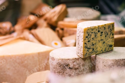 Preview: Piece of a blue cheese on a showcase in a French shop. Copy space.