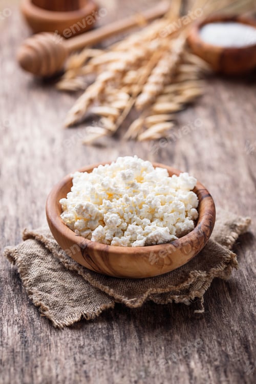 Preview: Bowl of Cottage Cheese with Wheat on Wood