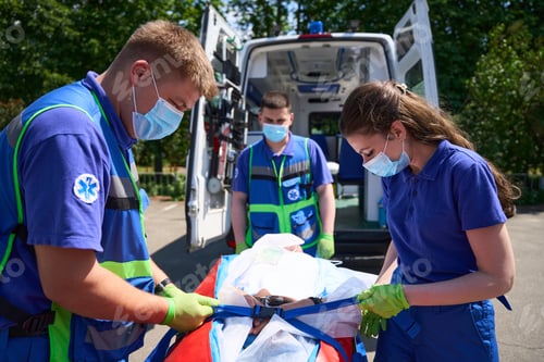 Preview: Man and a woman paramedics fix the patient for transportation