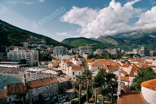 Preview: View over the red roofs of old houses to the beach near the new high-rise buildings. Budva