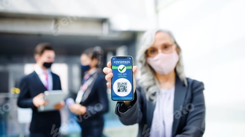Preview: Senior woman showing smartphone with covidpass, coronavirus, travel and new normal