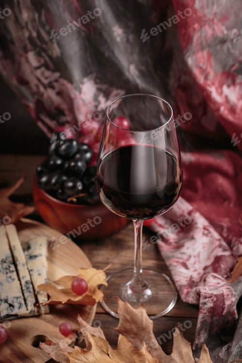 Preview: Autumn picnic with wine and cheese platter, fruits and dry leaves