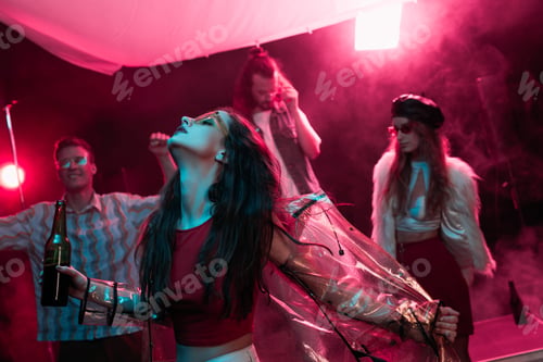 Preview: girl holding beer and dancing in nightclub with pink smoke