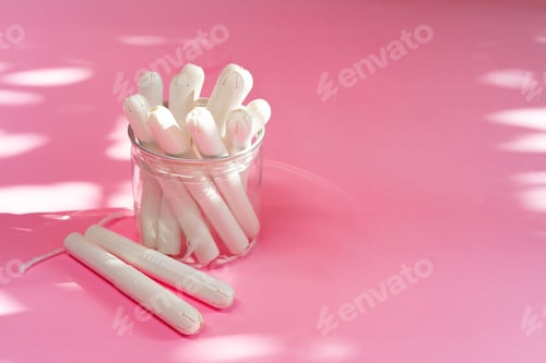Preview: Feminine hygienic tampons on pink paper background