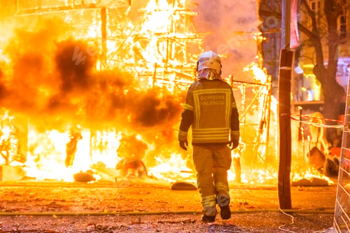 Preview: Firefighter with his protective suit working controlling the burning of a Falla