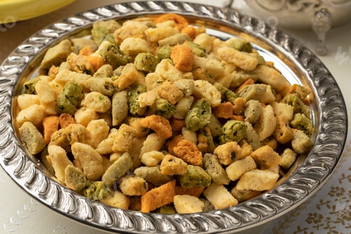 Preview: Metal bowl with colorful miniature shortbread cookies, called Krichlate close up