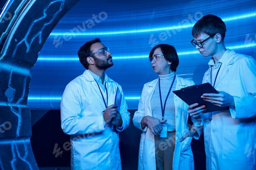 Preview: forward-thinking multiethnic scientists talking near young intern in innovation hub