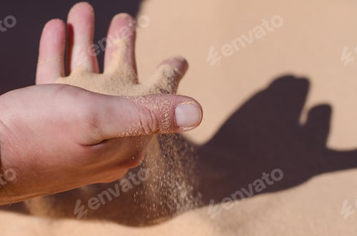 Preview: Desert. Sunny day. Sand pours through the fingers of a man. S