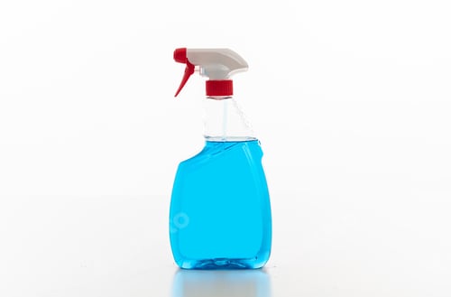 Preview: Cleaning spray bottle clear with blue color fluid isolated against white background.