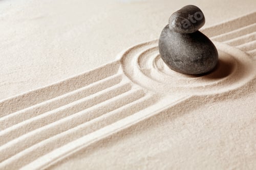 Preview: Stacked zen garden stones on sand with pattern, space for text. Meditation and harmony