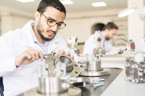 Preview: Busy worker assembling measuring devices in factory shop