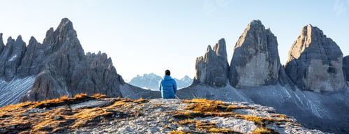 Preview: Tourist in blue jacket at Three Peaks of Lavaredo track on autumn season