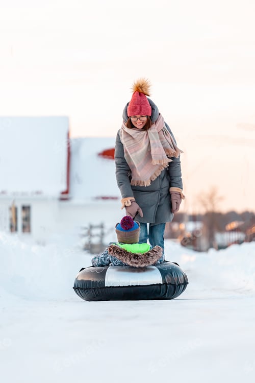 Preview: Family mom and child winter activity together on snow tubing on