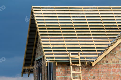 Preview: Close-up detail of new brick house top with two narrow plastic attic windows
