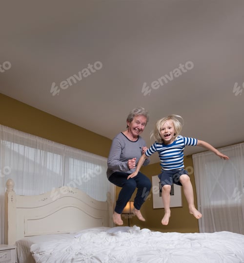 Preview: Grandson and grandmother jumping on bed