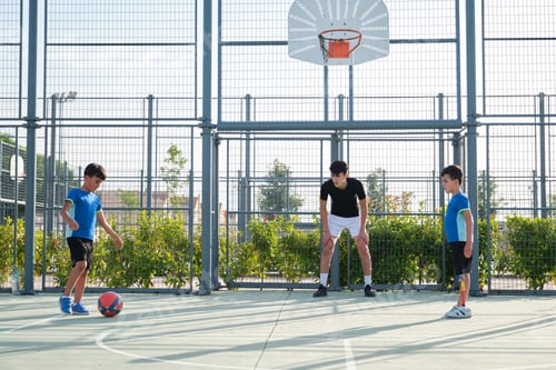 Preview: Three brothers playing football, one of them has a leg prosthesis and the other is kicking a penalty