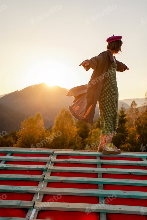 Preview: Woman enjoys beautiful sunset in the mountains