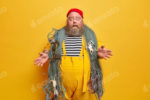 Preview: Fishing day. Puzzled surprised fisherman spreads palms and stares in disbelief, poses with necessary