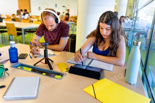 Preview: University classmates studying together in the library. Back to school.