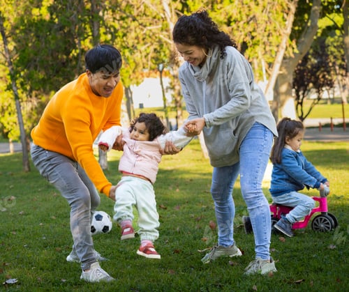 Preview: Hispanic family enjoying time together in a park on a sunny day