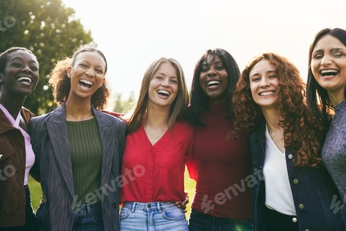 Preview: Multiracial female friends having fun hugging together outdoor - Focus on center girls faces