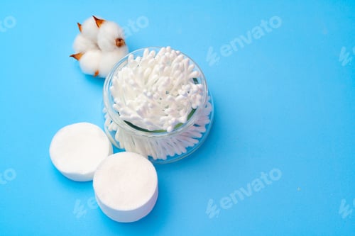 Preview: Set of cotton buds sticks on blue paper