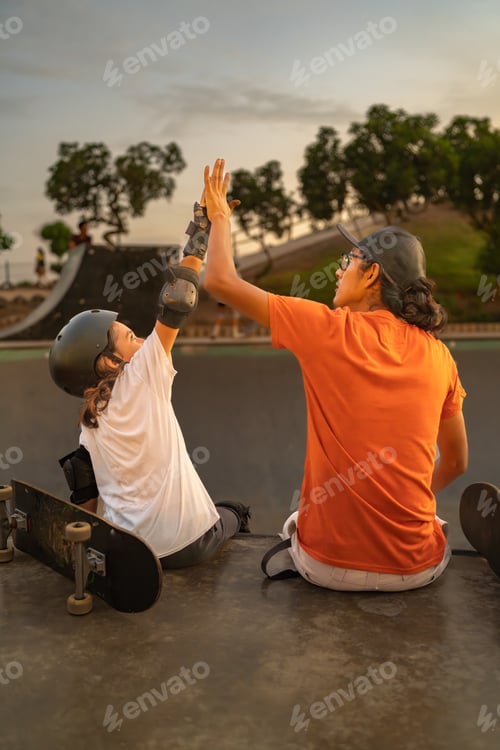 Preview: Skateboarder boy high-fiving his coach at the skate park