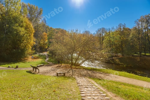 Preview: A scenic park view in Vilnius, Lithuania on a sunny autumn day, with a river and colorful trees