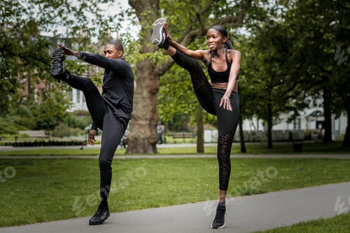 Preview: Black brother and sister twins doing exercise outdoors in stylish sportswear.