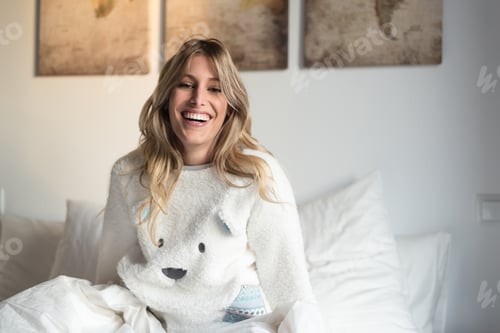 Preview: young beautiful happy blonde women on bed